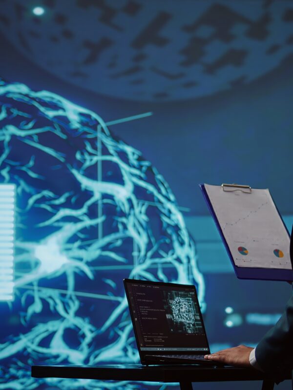 Startup employee looking over business charts, using AI software